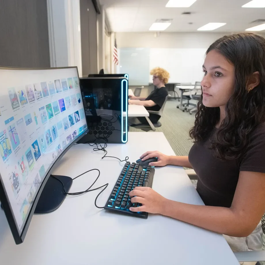 Decorative image of Charter Academy student working on the computer in class